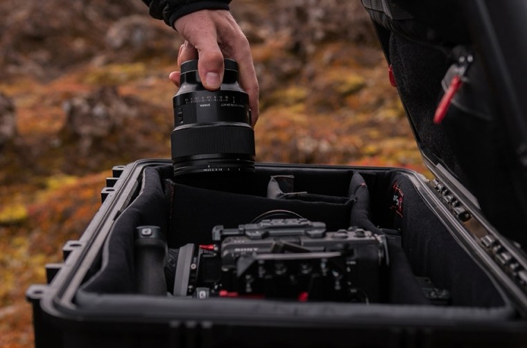 a rugged case with camera gear and lens for outdoor use