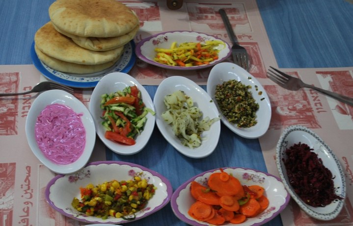 Food is served with a few salads in Israel.